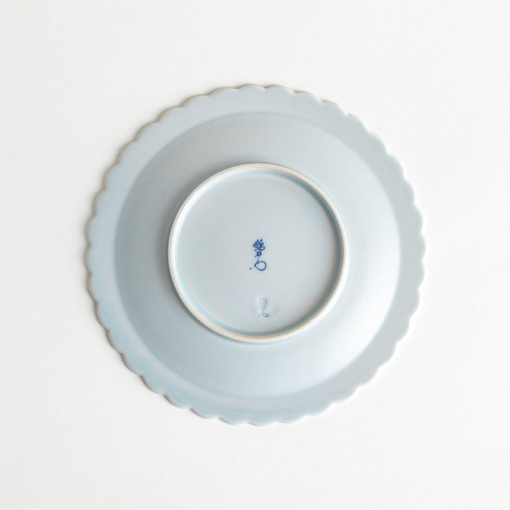 Fluted ceramic salad plate in matte black and light blue.