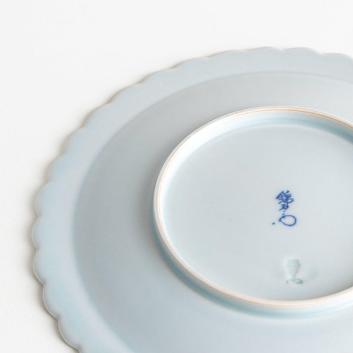 Fluted ceramic salad plate in matte black and light blue.