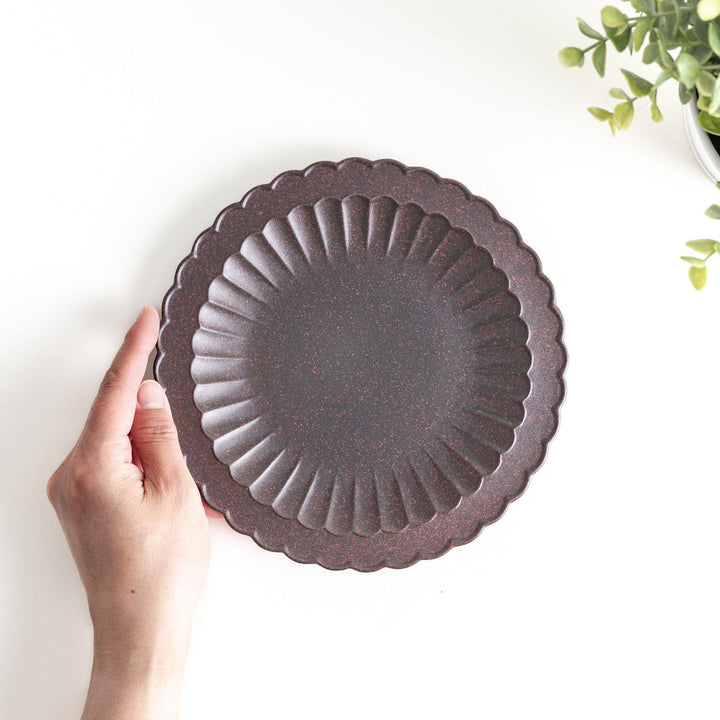 Fluted ceramic salad plate in matte black and light blue.