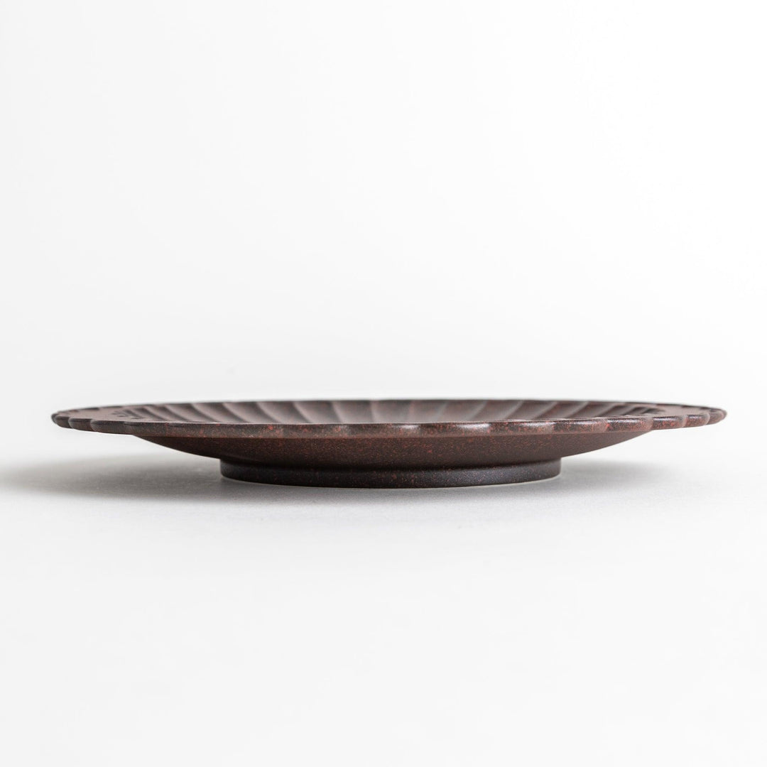 Fluted ceramic salad plate in matte black and light blue.