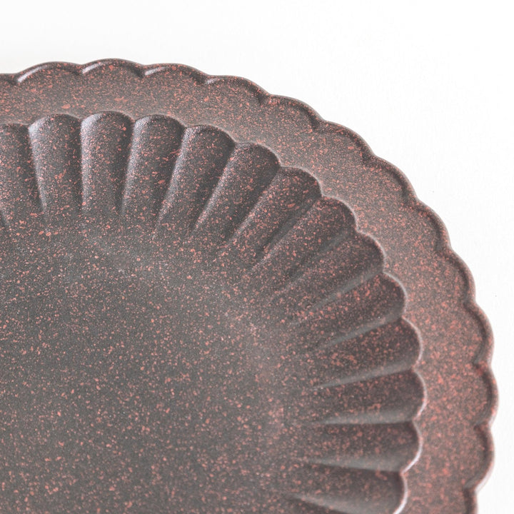 Fluted ceramic salad plate in matte black and light blue.