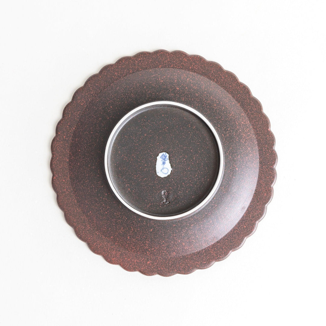 Fluted ceramic salad plate in matte black and light blue.