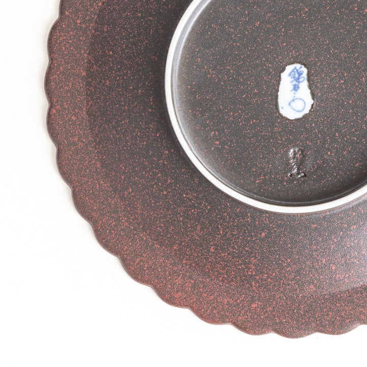 Fluted ceramic salad plate in matte black and light blue.