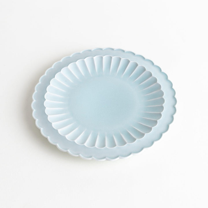 Fluted ceramic salad plate in matte black and light blue.