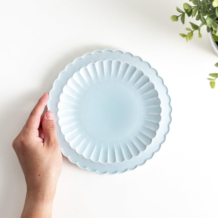 Fluted ceramic salad plate in matte black and light blue.