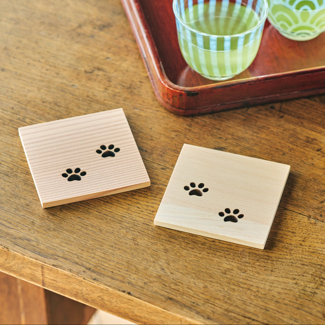 Square Japanese cedar wooden coaster with cute cat paw cutouts used with iced tea for a relaxing tea time