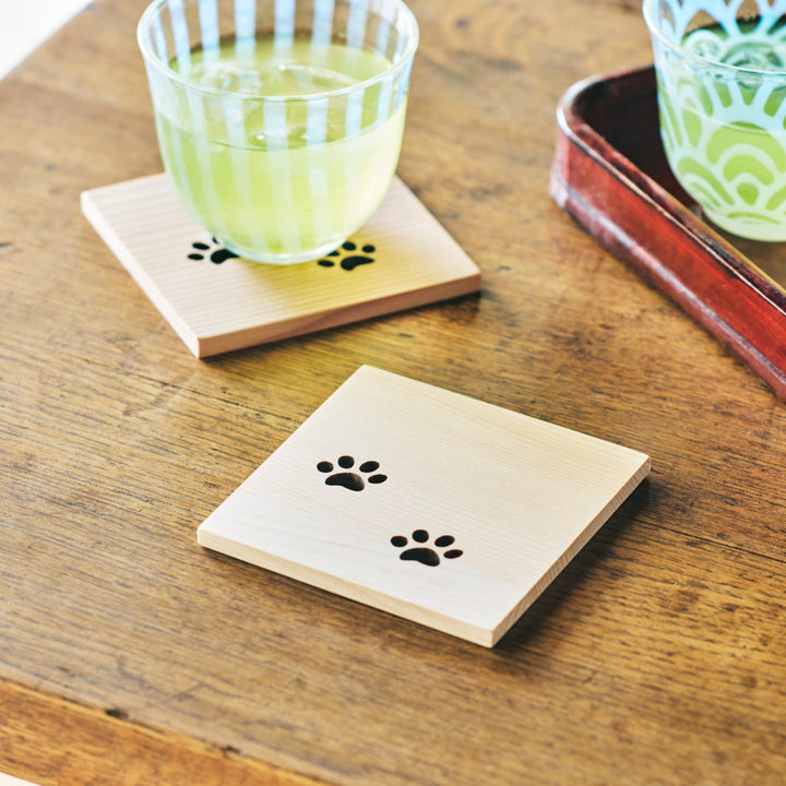 Square Japanese cedar wooden coaster with cute cat paw cutouts used with iced tea for a relaxing tea time