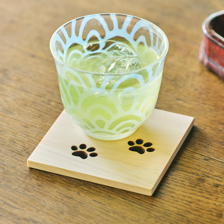 Square Japanese cedar wooden coaster with cute cat paw cutouts used with iced tea for a relaxing tea time