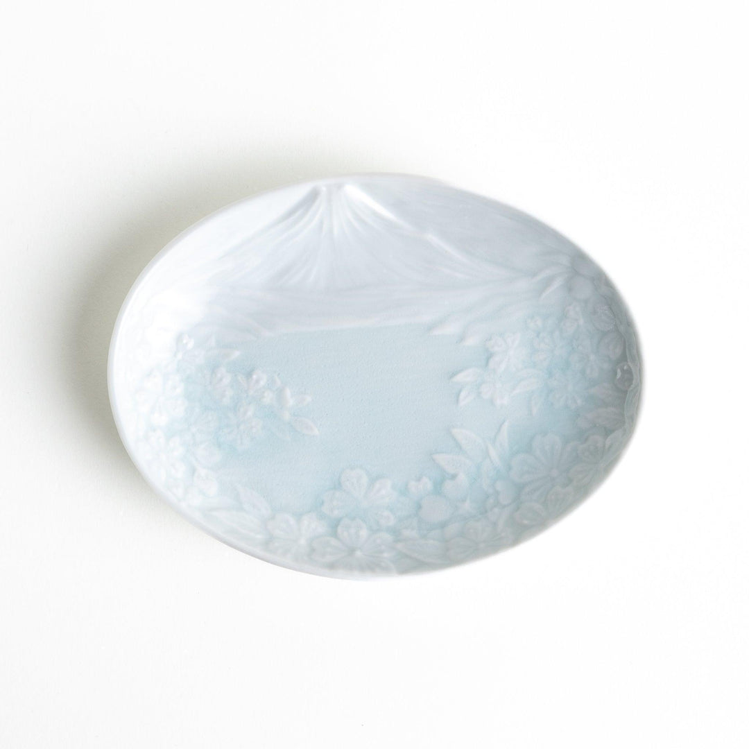 Round celadon dessert plate with raised Mount Fuji pattern and glossy finish symbolizing Japanese nature.