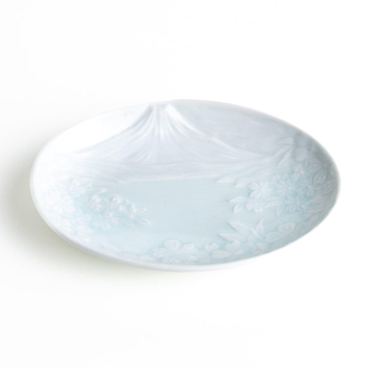 Round celadon dessert plate with raised Mount Fuji pattern and glossy finish symbolizing Japanese nature.