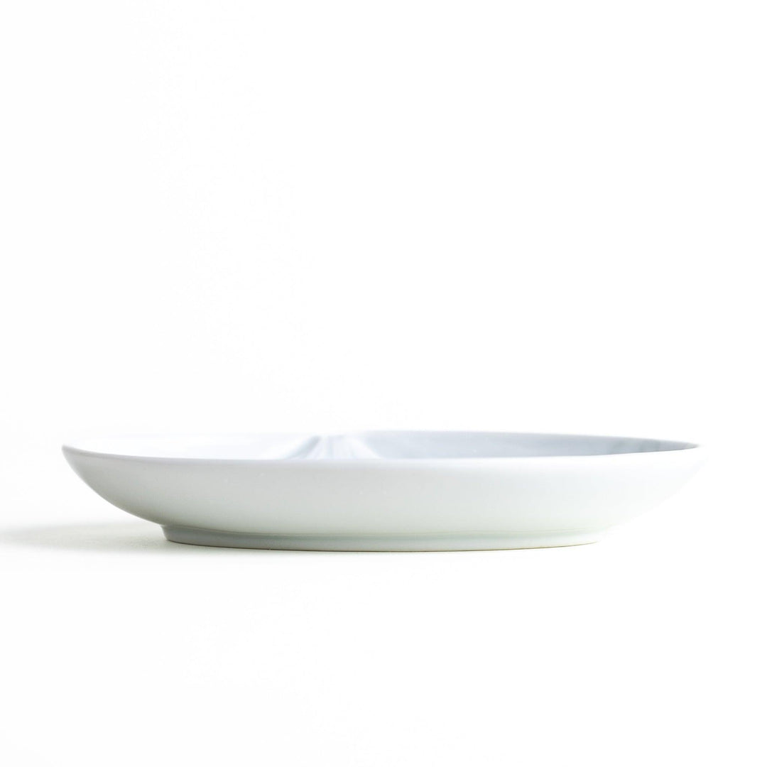 Round celadon dessert plate with raised Mount Fuji pattern and glossy finish symbolizing Japanese nature.