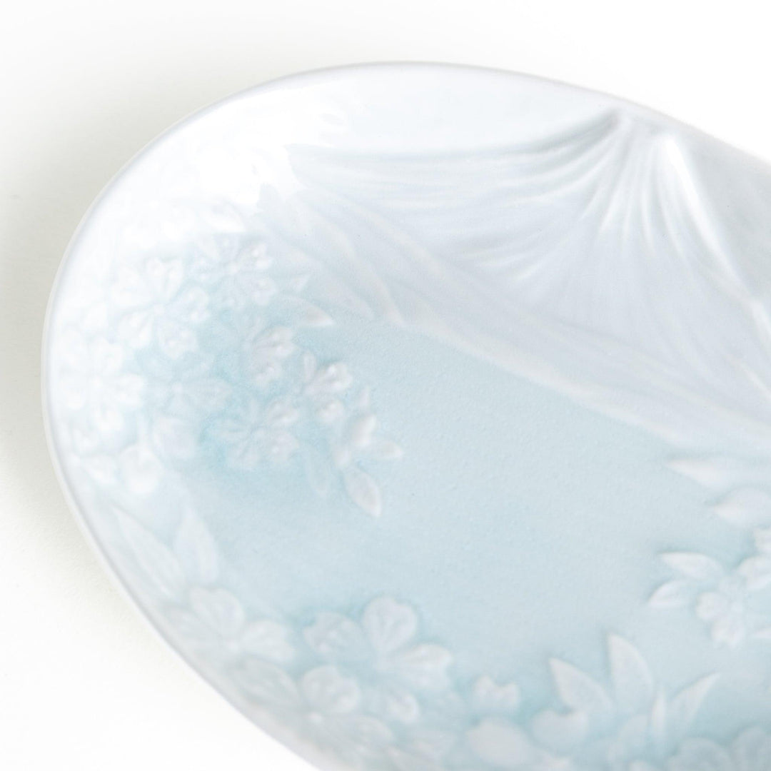 Round celadon dessert plate with raised Mount Fuji pattern and glossy finish symbolizing Japanese nature.