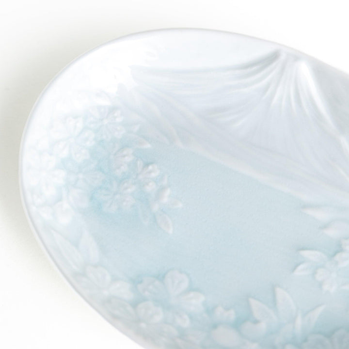 Round celadon dessert plate with raised Mount Fuji pattern and glossy finish symbolizing Japanese nature.