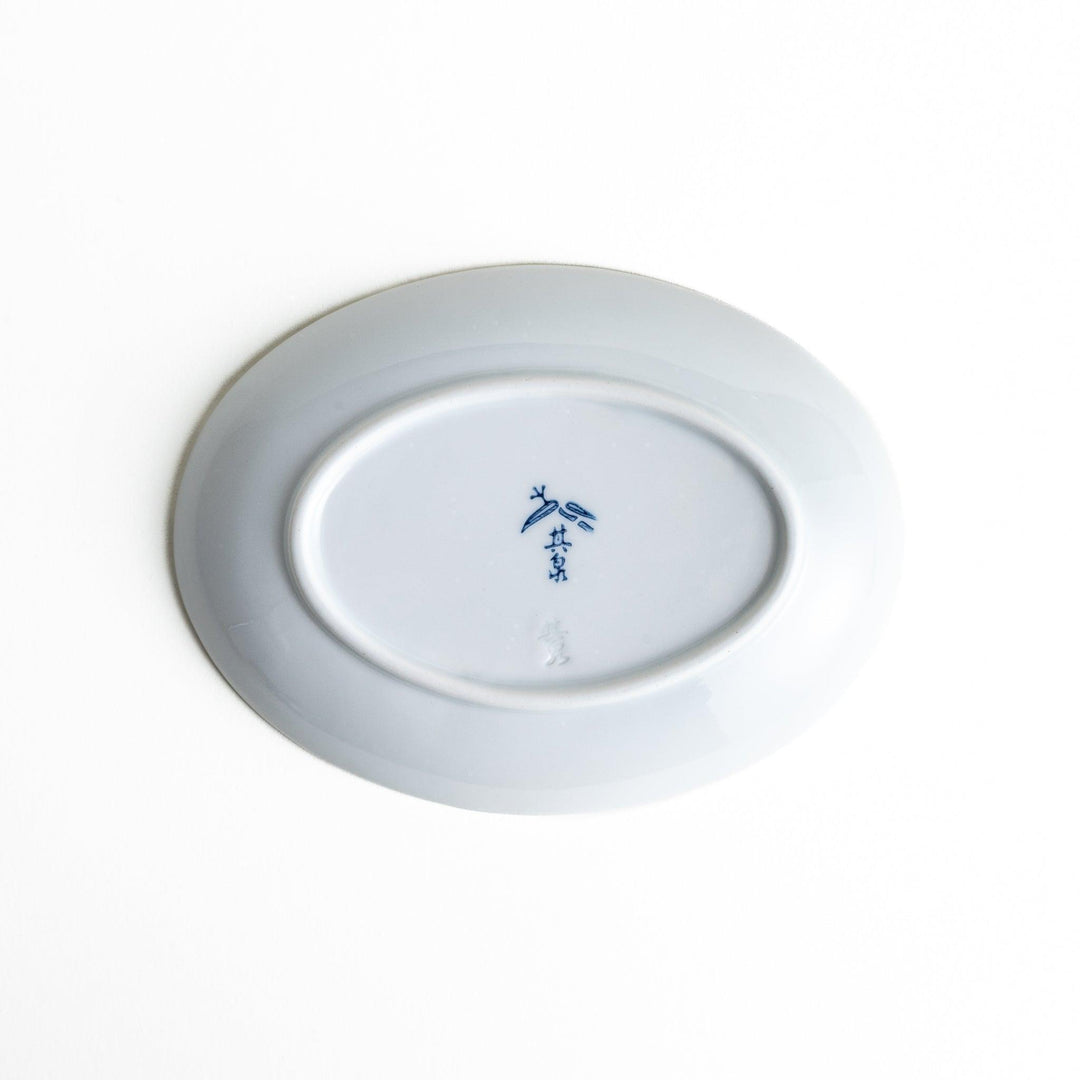 Round celadon dessert plate with raised Mount Fuji pattern and glossy finish symbolizing Japanese nature.