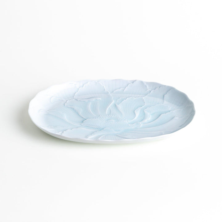 A large oval serving plate with a subtle raised floral design in celadon, featuring a delicate pattern of petals.