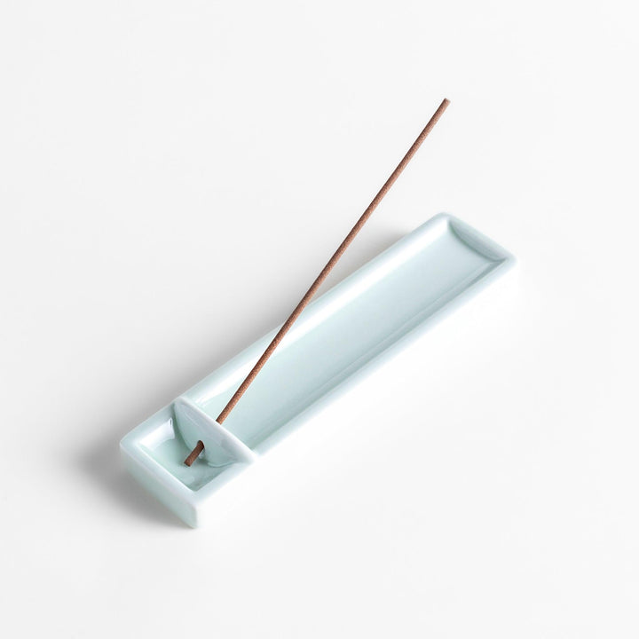Celadon ceramic incense holder with built-in slot and rectangular shape elegantly catching falling incense ash.
