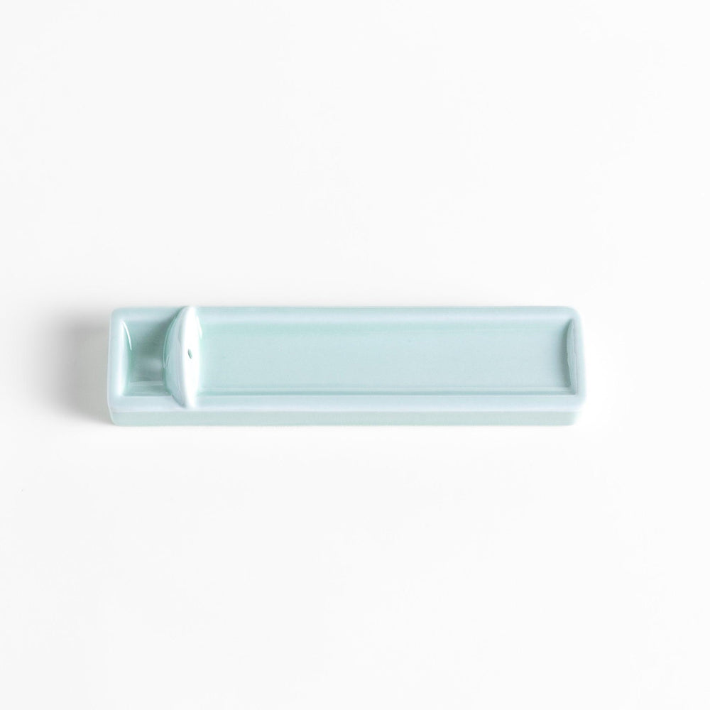 Celadon ceramic incense holder with built-in slot and rectangular shape elegantly catching falling incense ash.
