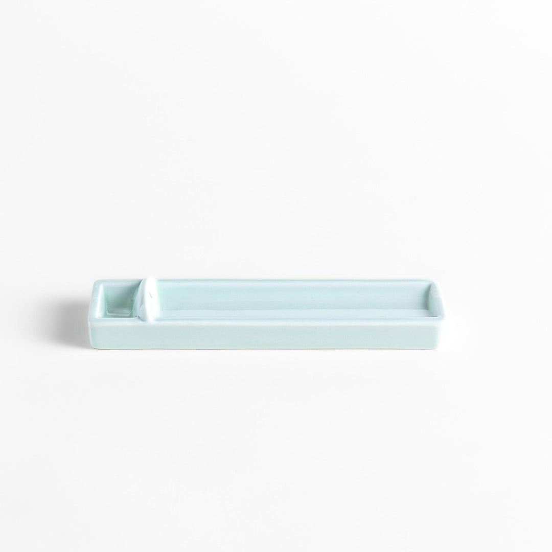 Celadon ceramic incense holder with built-in slot and rectangular shape elegantly catching falling incense ash.