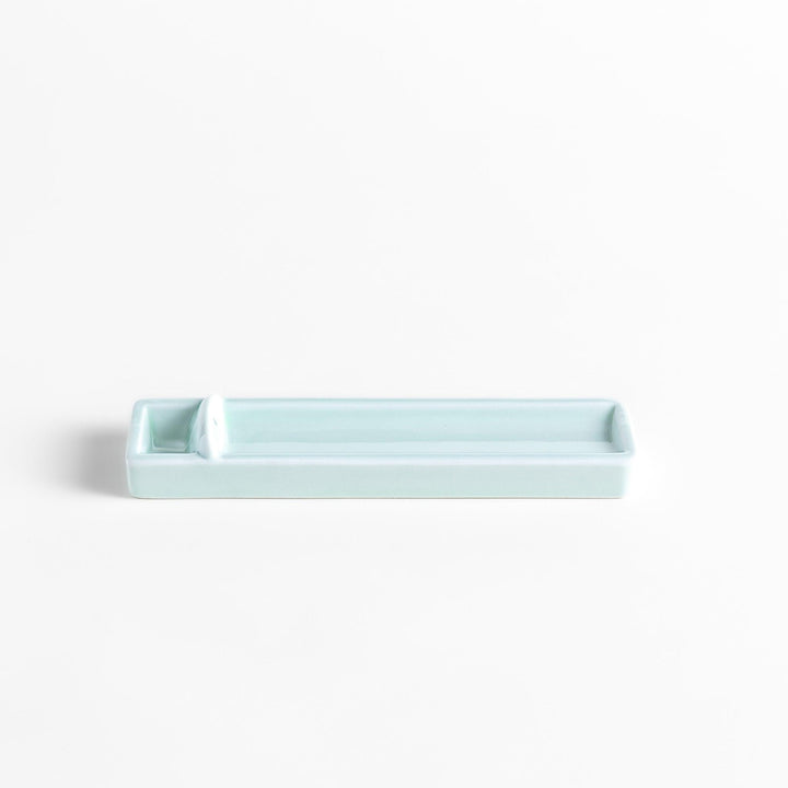 Celadon ceramic incense holder with built-in slot and rectangular shape elegantly catching falling incense ash.