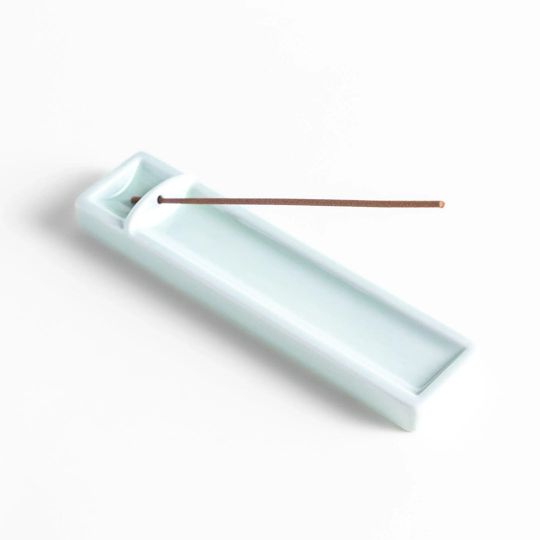 Celadon ceramic incense holder with built-in slot and rectangular shape elegantly catching falling incense ash.