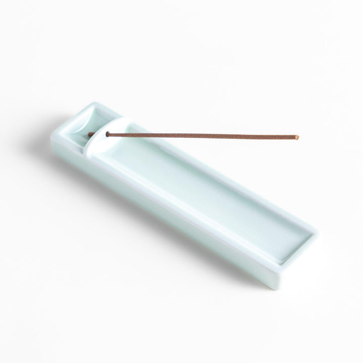 Celadon ceramic incense holder with built-in slot and rectangular shape elegantly catching falling incense ash.