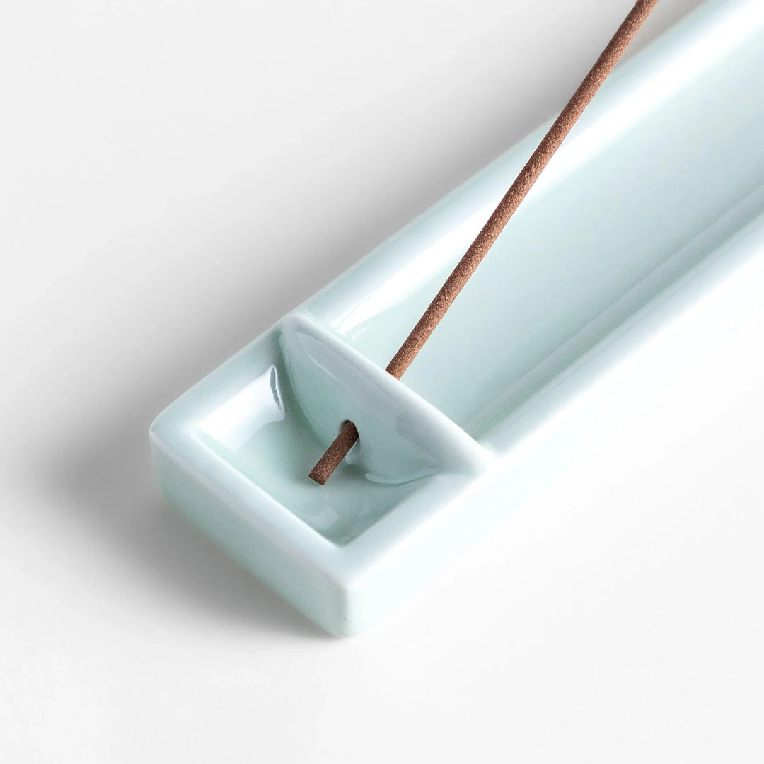 Celadon ceramic incense holder with built-in slot and rectangular shape elegantly catching falling incense ash.
