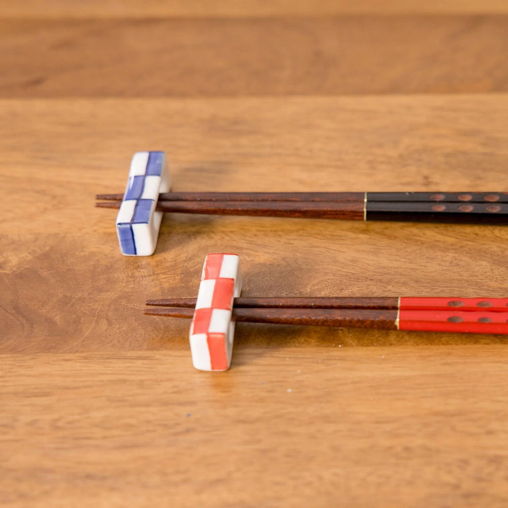Colorful red and blue chopstick rests side by side, highlighting their unique design.