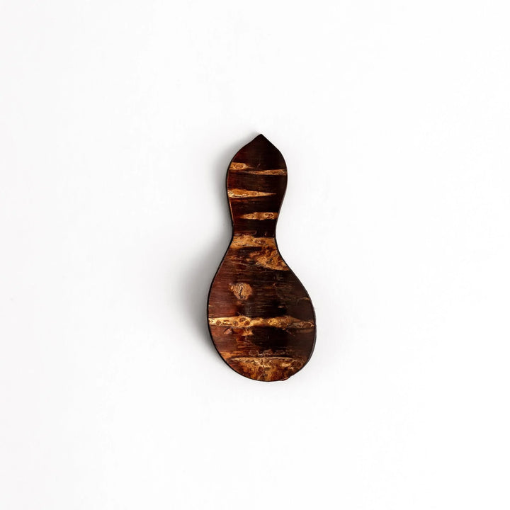 Cherry bark tea scoop with curved design and natural grain perfect for measuring loose leaf tea with artistry.