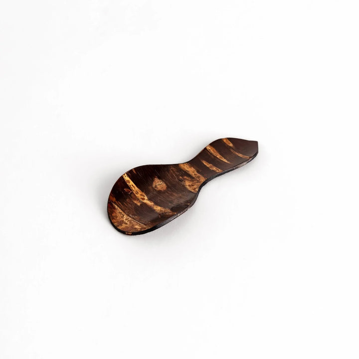 Cherry bark tea scoop with curved design and natural grain perfect for measuring loose leaf tea with artistry.