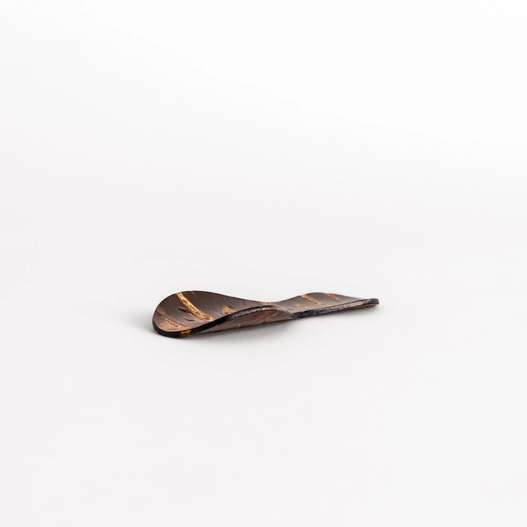 Cherry bark tea scoop with curved design and natural grain perfect for measuring loose leaf tea with artistry.