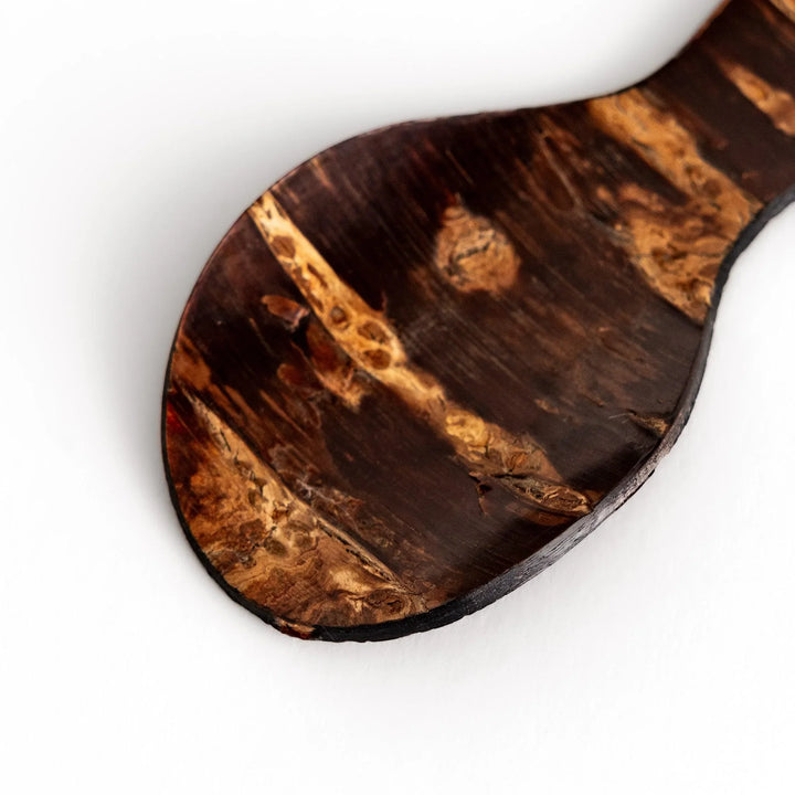 Cherry bark tea scoop with curved design and natural grain perfect for measuring loose leaf tea with artistry.