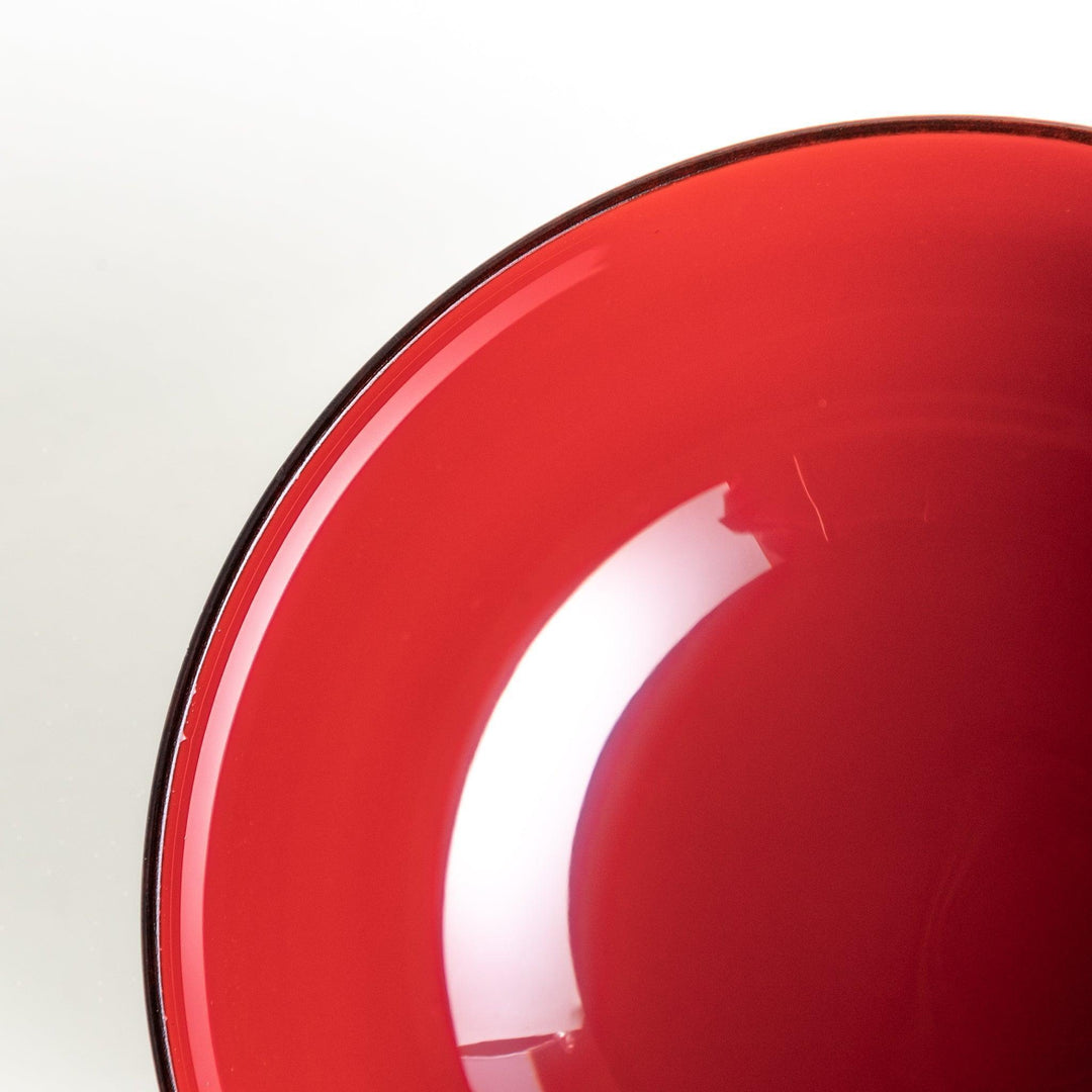 A wooden soup bowl with a rich, brown grain finish and a deep red interior.