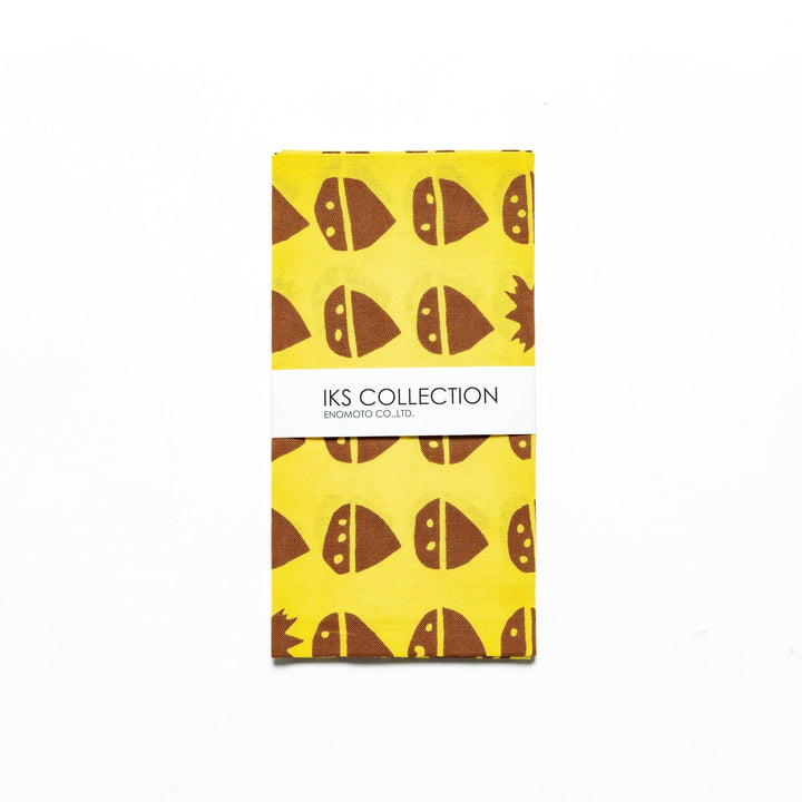 Folded yellow tenugui with chestnut motifs, neatly presented with a product sleeve.