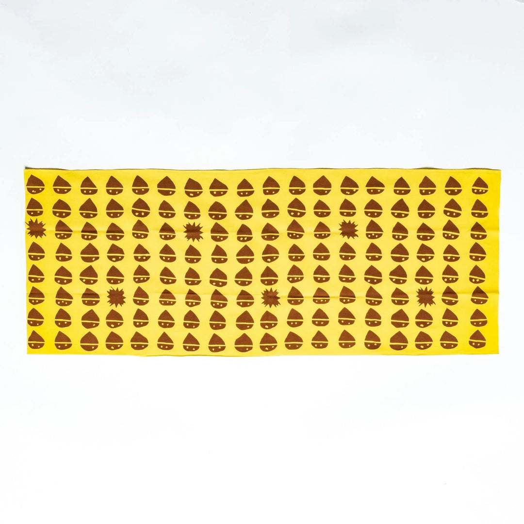 Fully spread yellow tenugui displaying uniform brown chestnut patterns and starburst accents.