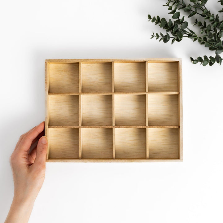 Wooden chopstick rest organizer with 12 sections, ideal for storing and displaying various chopstick rests.