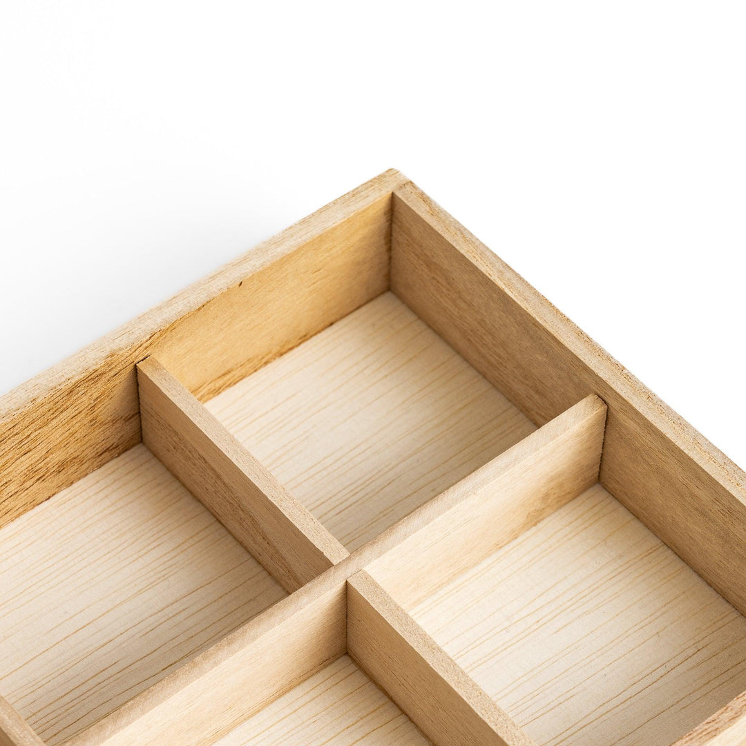 Wooden chopstick rest organizer with 12 sections, ideal for storing and displaying various chopstick rests.