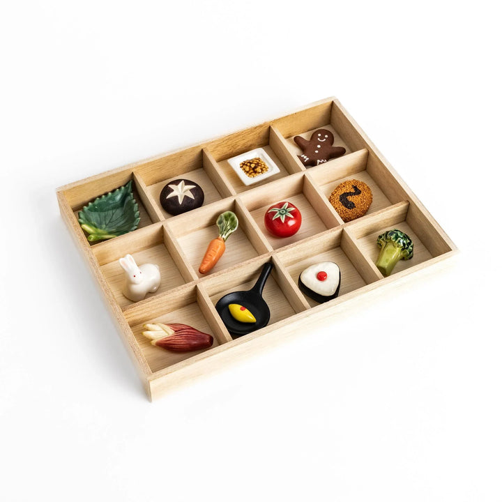 Wooden chopstick rest organizer with 12 sections, ideal for storing and displaying various chopstick rests.