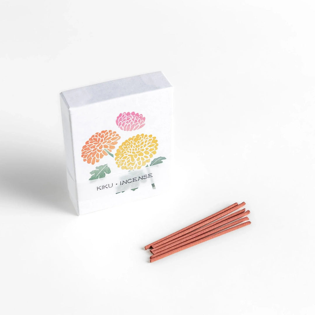 Incense with brown sticks in a chrysanthemum box, offering a refined floral aroma for a calm setting.