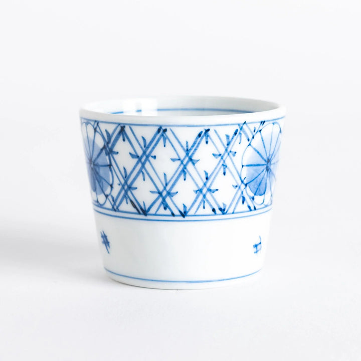 A small white condiment bowl with a delicate blue chrysanthemum and lattice pattern on the exterior.