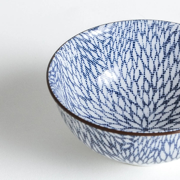 Close-up shot highlighting the delicate blue chrysanthemum leaves pattern within the bowl.