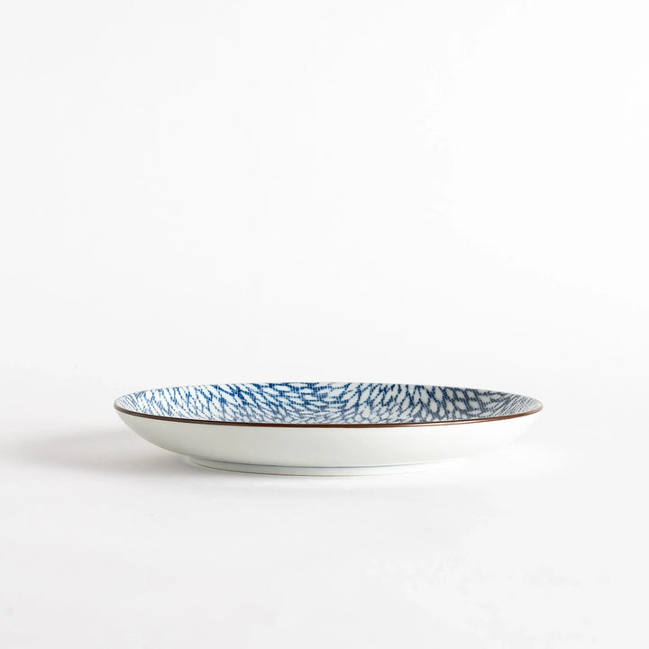 A salad plate with a detailed blue herringbone pattern radiating from the center.