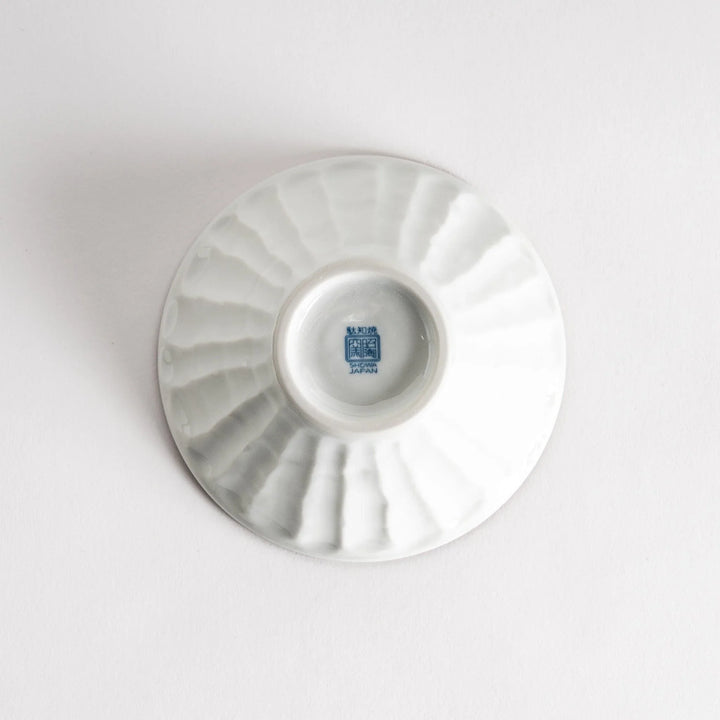 A small fluted bowl with a blue herringbone pattern on a white background.