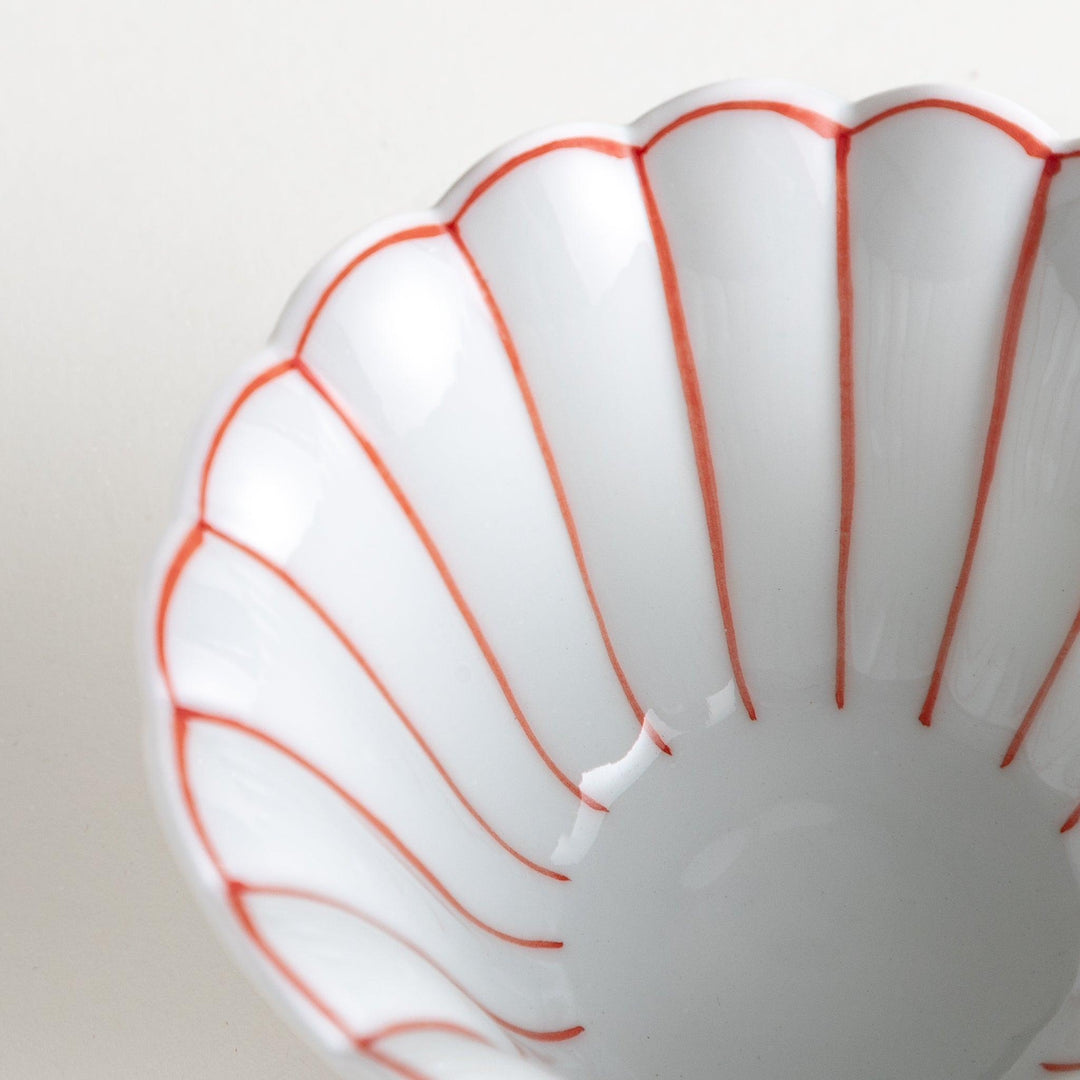 Scalloped edge condiment bowls, one with blue stripes and the other with red stripes