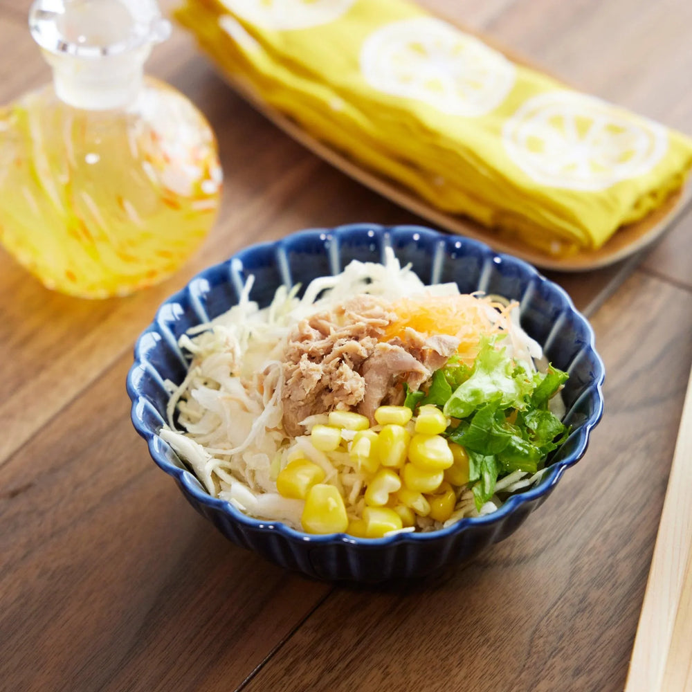 Chrysanthemum Navy Blue Dessert Bowl filled with shredded cabbage, corn, tuna, and greens, placed on a wooden table.