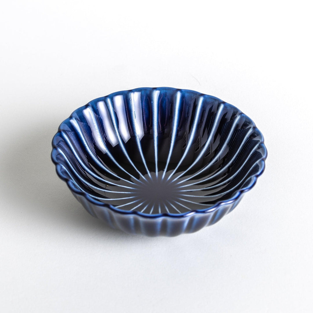 A blue dessert bowl featuring a ribbed pattern from the center outward.