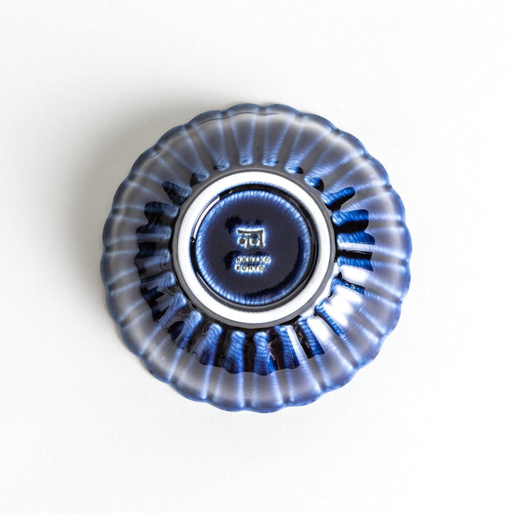 A blue dessert bowl featuring a ribbed pattern from the center outward.