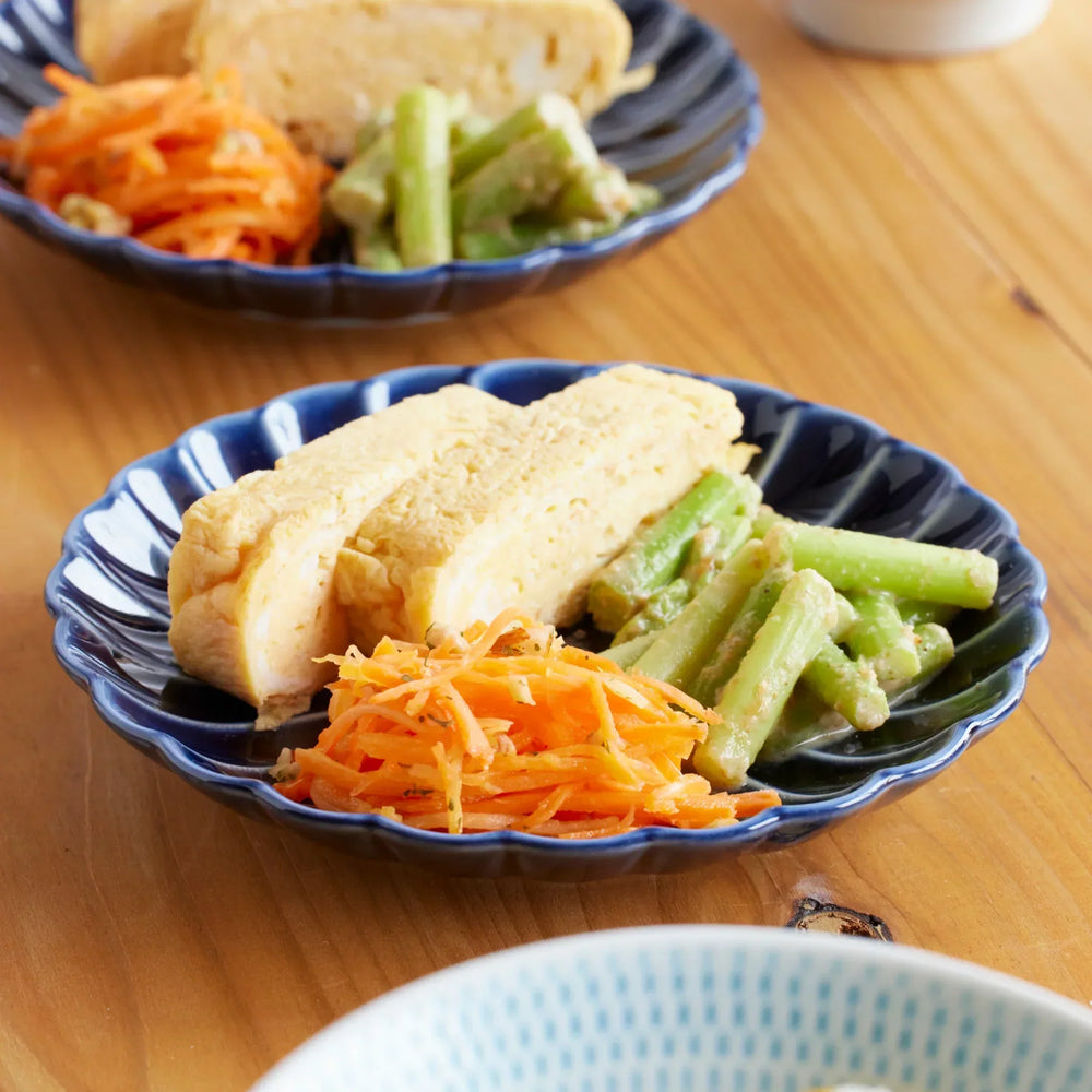 Japanese blue chrysanthemum small plate with tamagoyaki carrots and beans showcasing handmade craft.