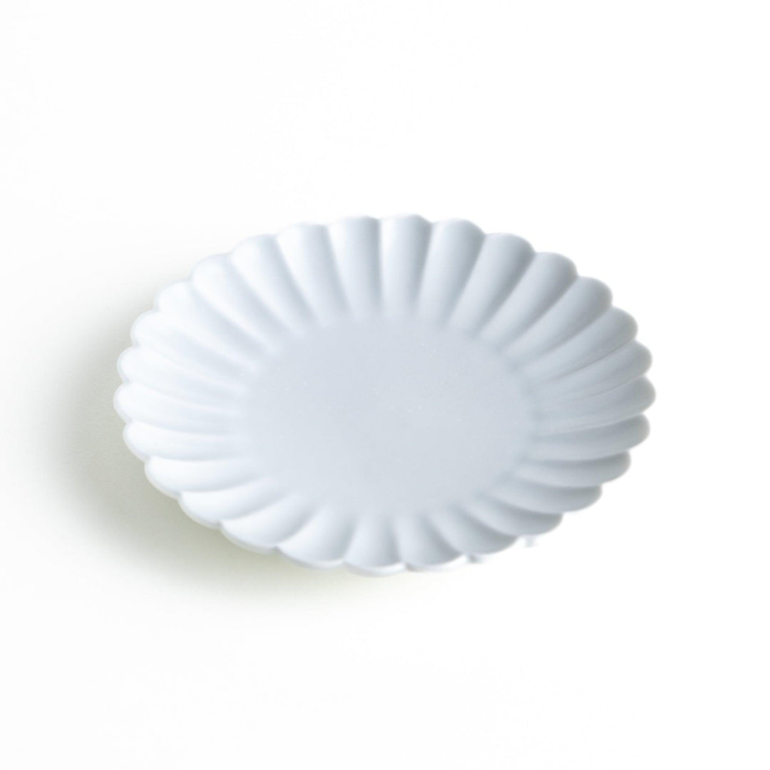 Small sauce dish in various colors (white, green, yellow) with scalloped edges.
