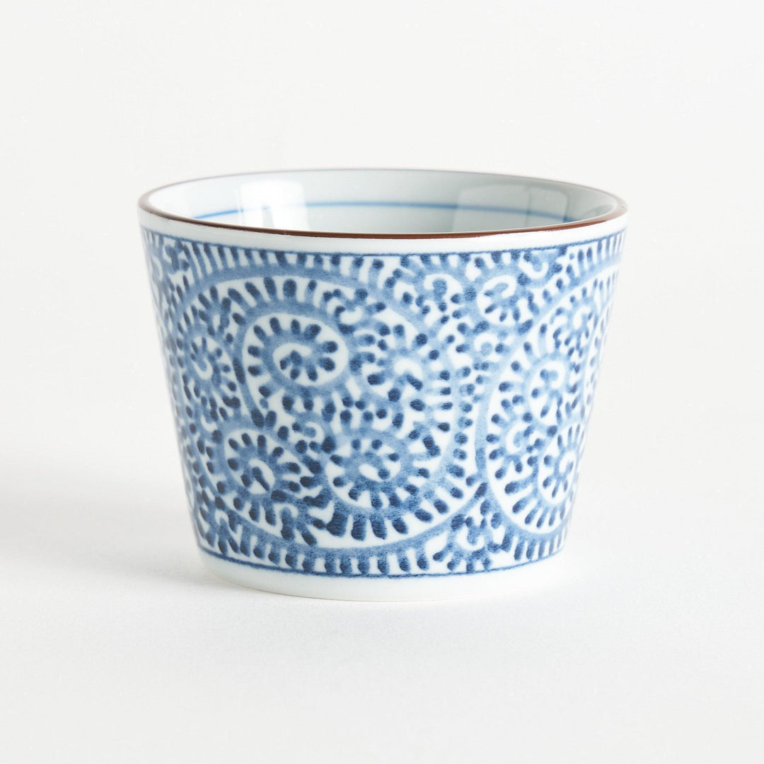 A small cylindrical cup featuring a detailed blue spiral pattern on a white base.
