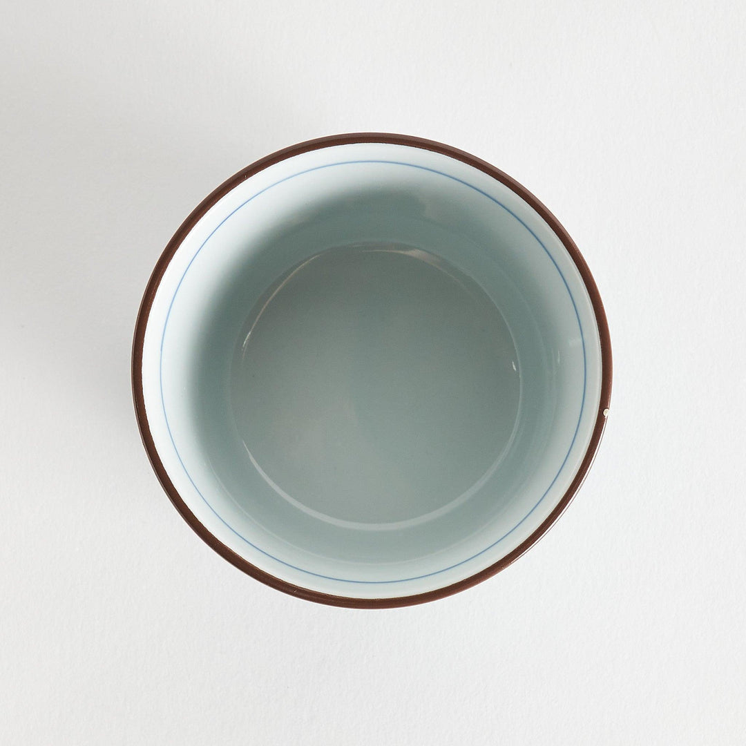 A small cylindrical cup featuring a detailed blue spiral pattern on a white base.